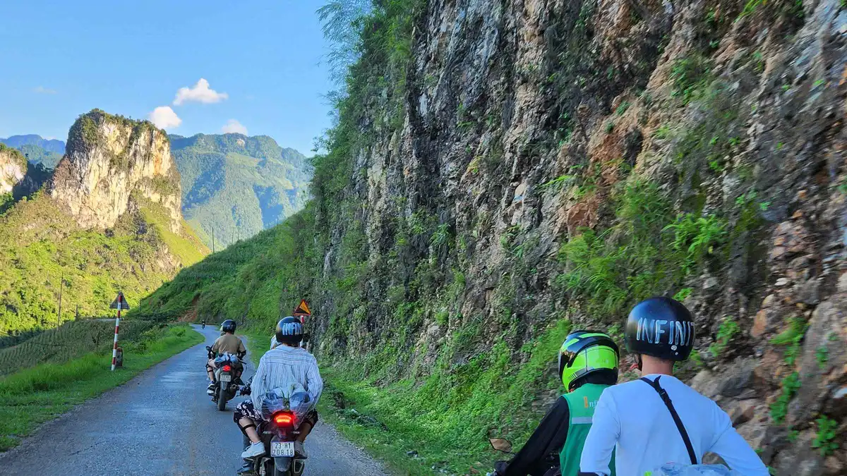 Riders leaving Ha Giang city at sunrise at the start of a 3-day Ha Giang loop motorcycle tour, northern Vietnam